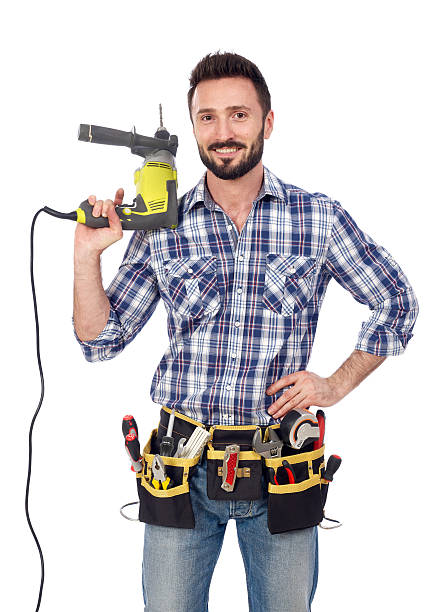 istock A handyman in a checked shirt holding a drill on white 466249920