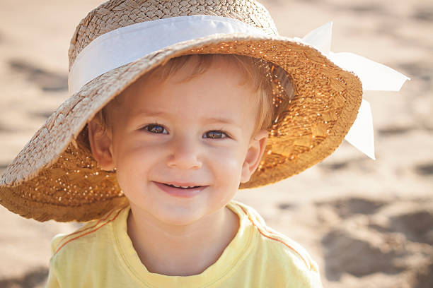 istock Cute little boy playing at the beach with mom's hat 466250836