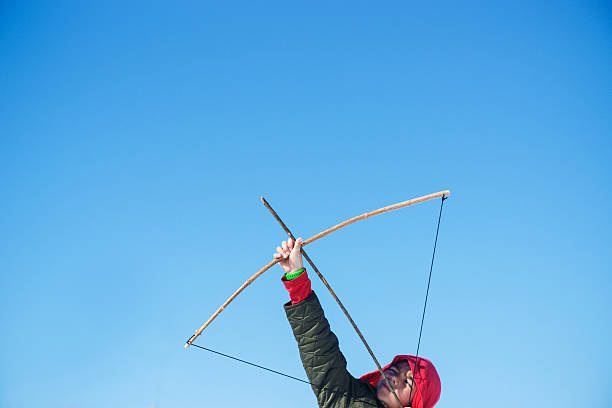 istock Young boy aiming his arrow into the sky 466250852