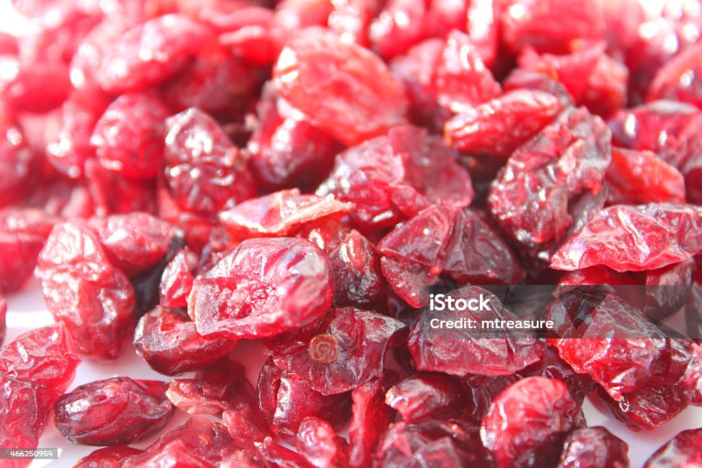 Image showing pile of dried cranberries / red cranberry fruit healthy-snacks Photo showing a pile of purple / red cranberries, lit by natural light.  Cranberry dried fruit is a very convenient way to eat this berry, since you can easily snack on them at anytime, as well as using them for cooking and baking, adding more colour to muffins than boring brown sultanas. 2015 Stock Photo