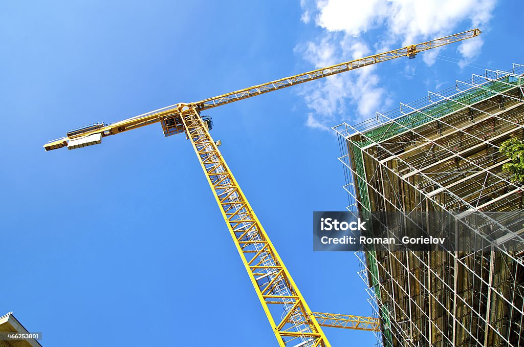 construction yellow crane builds a construction Activity Stock Photo