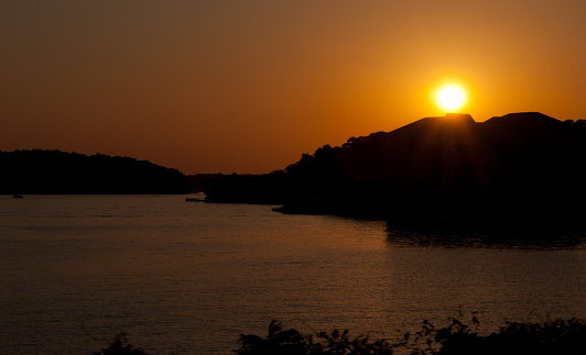 The Sun Sets Over Large Tropical Lake