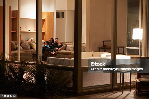 Family Watching Tv At Home Viewed From Outside Stock Photo - Download Image Now - Family, Night, Window