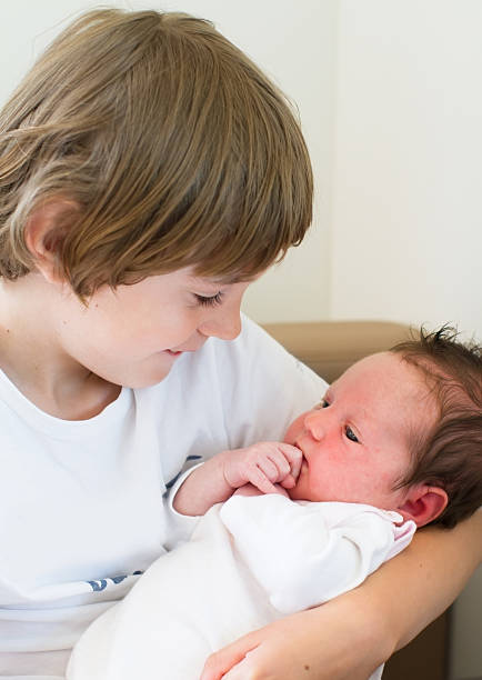 istock Brother holding his baby sister 466256375