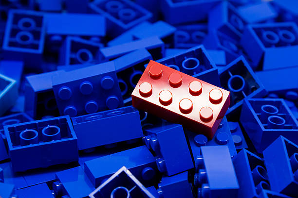 istock Pile of blue building blocks with focus on red block 466261560
