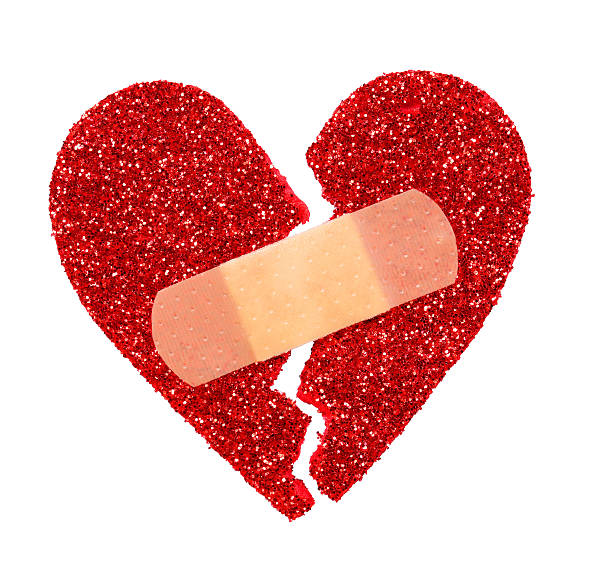 istock Broken Heart. Glitter ripped and fixed with adhesive bandage isolated 466263443