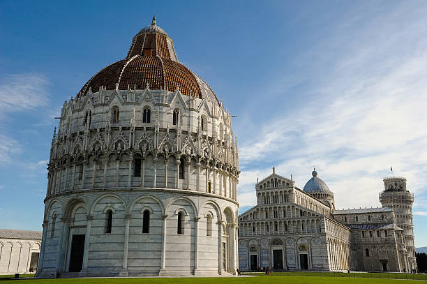 Italy - March 4, 2011: The Pisa Bapistery in Piazza dei Miracoli with the Pisa Cathedral and Leaning Tower of Pisa in the background in Pisa, Italy. pisa leaning tower of pisa tower famous place stock pictures, royalty-free photos & images