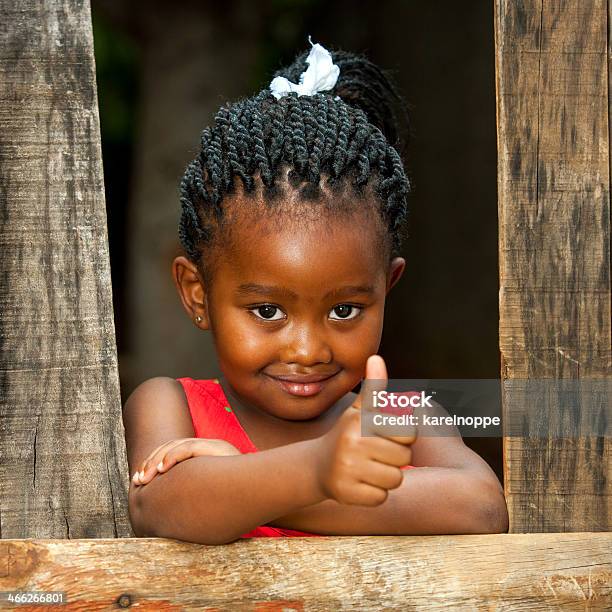 Little African Girl At Wooden Fence With Thumbs Up Stock Photo - Download Image Now