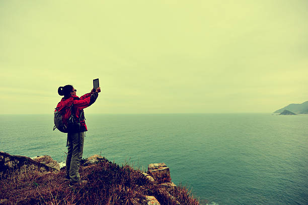 istock hiking woman seaside mountain peak 466268184