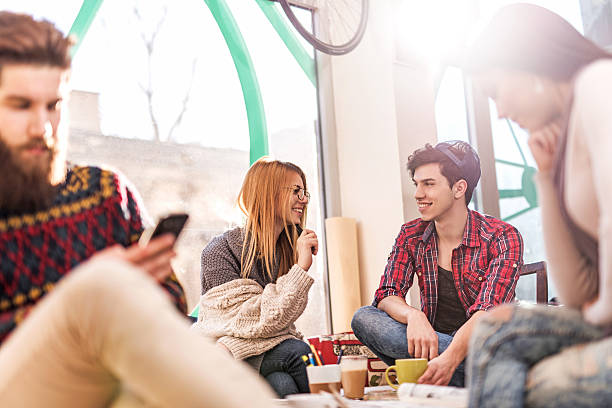 istock Happy young adults having a break in cafe and talking. 466269848