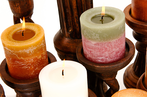 Assortment of decorative scented candles shot on a white background.