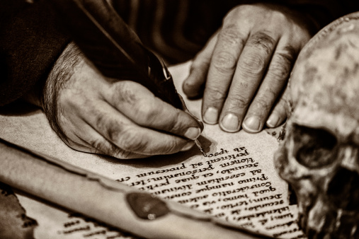 Hands writing document  in latin Toned image