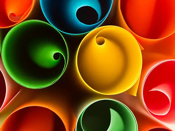 macro image, top view of group of rolled up colorful sheets of paper