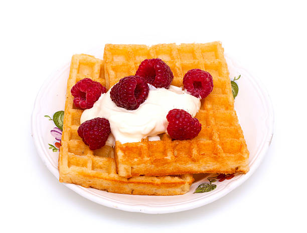istock waffles with wheaped cream and raspberrries 466274857