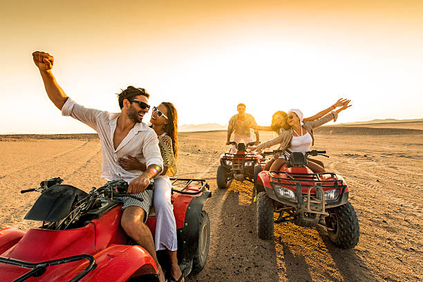 istock Friends having fun riding quad bikes in desert 466275296