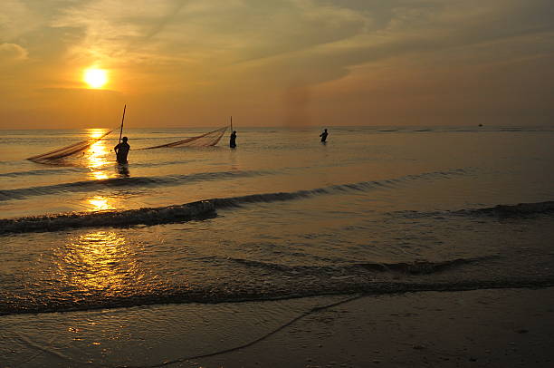 istock Sea and fisherman at sunset 466275764