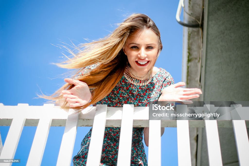 Beautiful Young Woman Bending Over A Balcony Stock Photo Download