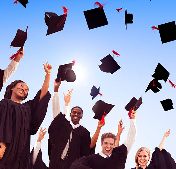 istock Graduation Caps Throwing Air Concept 466276630
