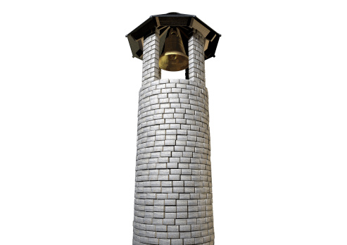 A plain stone tower turret bell tower with a wood and iron roof and a golden metal bell on an isolated white background