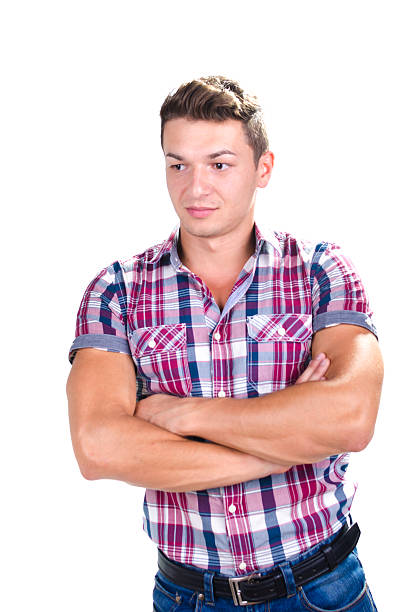 istock Portrait of young man standing with folded arms 466281131