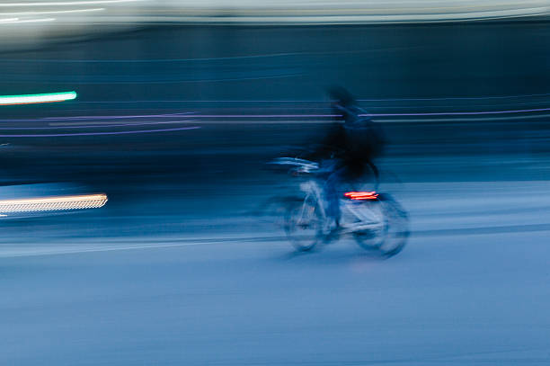 istock Man Riding a Bicycle in a Blurred City Scene 466281628