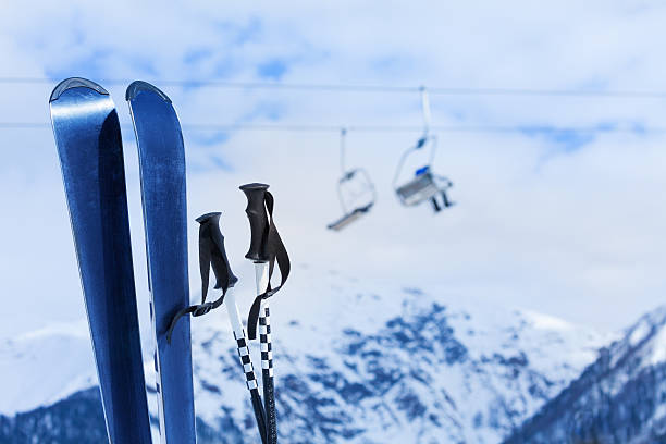istock Mountain ski and poles with snow peak 466282116