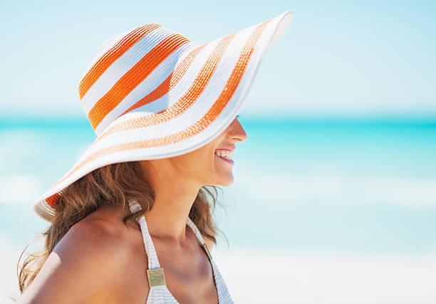 istock Happy woman in swimsuit and hat looking on copy space 466282623