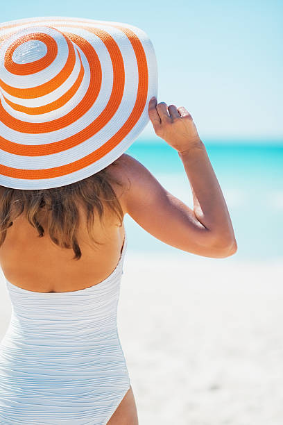 istock Backside of a woman wearing a large hat at beach 466282645
