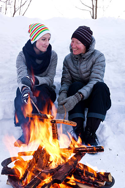 istock Mother and Daughter Cook Hot Dogs Over a Fire Pit. 466285344