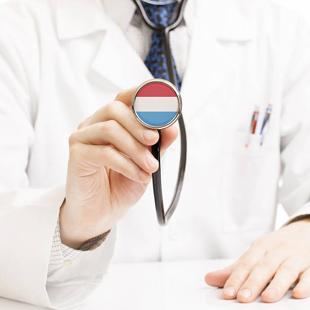 istock Doctor holding stethoscope with flag series - Luxembourg 466285422