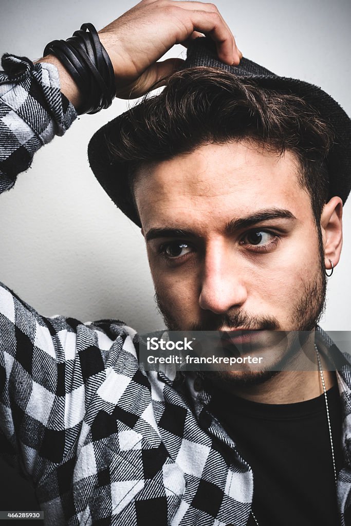 fashionable young adult posing on whie wall fashionable young adult posing serious 18-19 Years Stock Photo