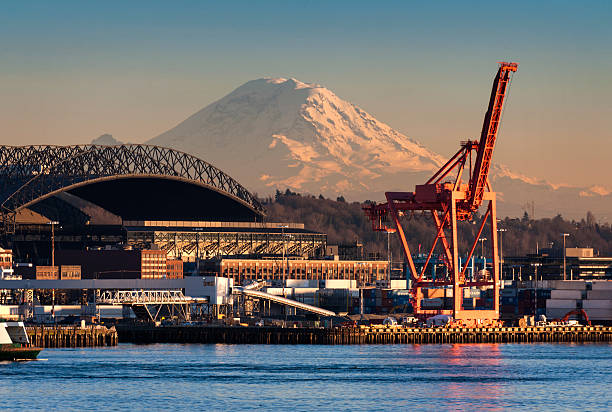 Mount Rainier and the Seattle waterfront Mt. Rainier looms large over the Port of Seattle on Elliott Bay during a lovely winter sunset. elliott bay photos stock pictures, royalty-free photos & images