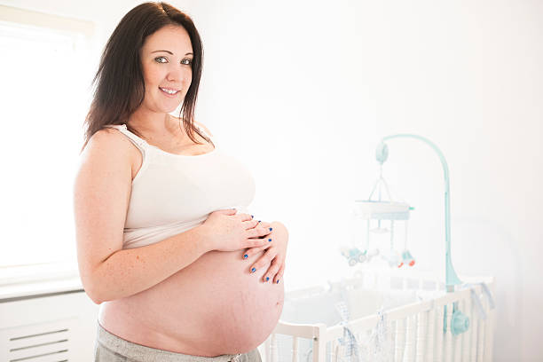 istock Pregnant woman in baby's nursery 466287418