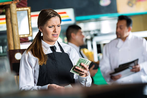 Waitress in Tex-Mex restaurant disappointed in small tip from customer Waitress in Tex-Mex restaurant disappointed in small tip from customer mex mexican restaurant tex stock pictures, royalty-free photos & images