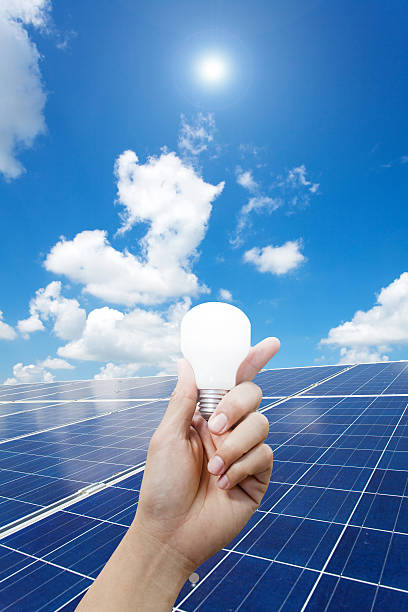 istock Solar energy panels and Light bulb in hand 466291006