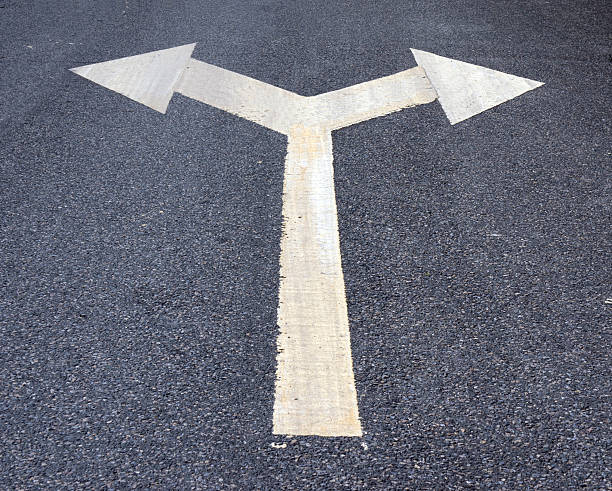 istock Two way arrow symbol on an asphalt road surface. 466291794