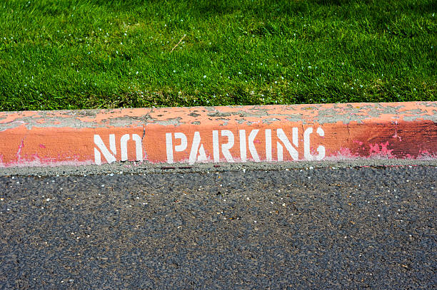 istock Red painted curb with a no parking sign 466292686