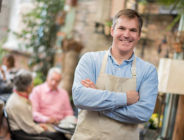 istock Man serving tables at a coffee shop 466295624