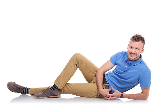 istock happy young man lying on the floor 466297172