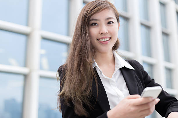 istock asian successful businesswoman using smart phone at office corridor 466301052