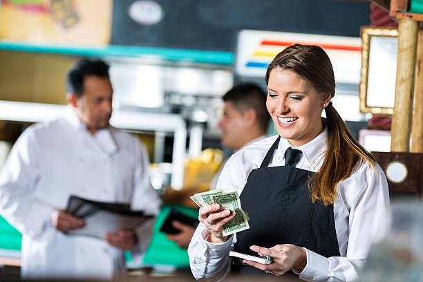 istock Happy waitress counting money after shift in Tex-Mex restaurant 466303236
