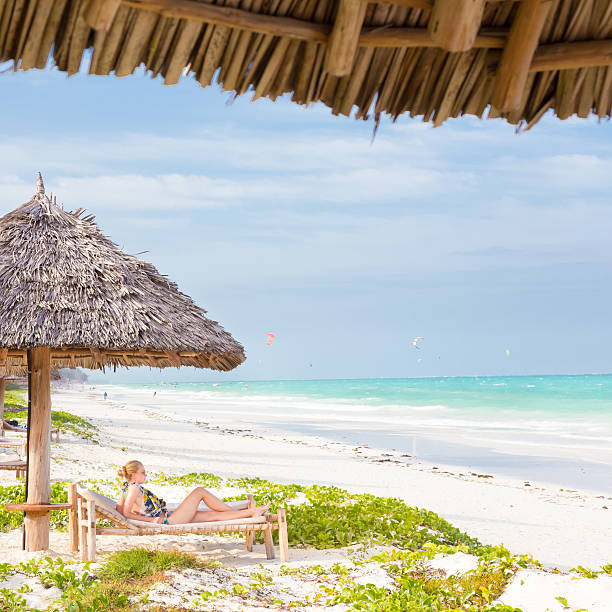 istock Woman sunbathing on tropical beach. 466304690