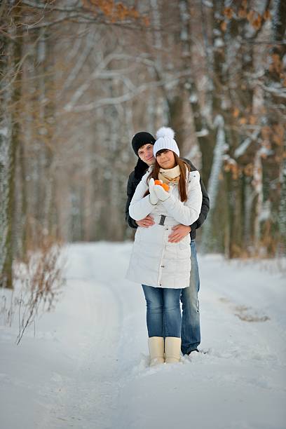istock Couple with tangerines in winter forest 466305481