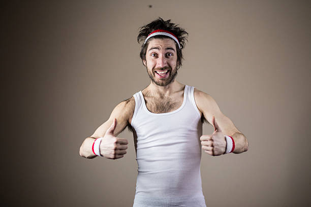 Funny sports nerd posing with thumbs up Funny sports nerd posing Funny sports nerd posing with thumbs up skinny stock pictures, royalty-free photos & images