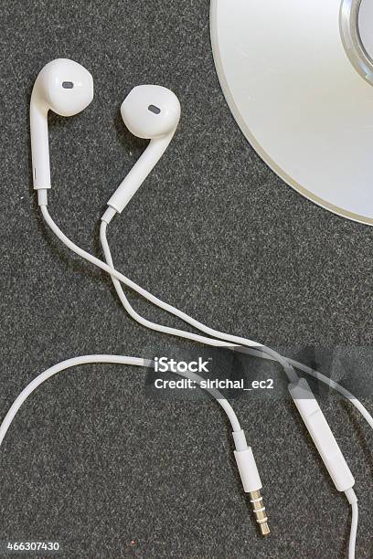 Earphones On A Fabric Background Stock Photo - Download Image Now - 2015, Arts Culture and Entertainment, Audio Equipment