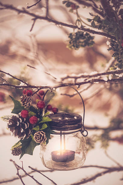 istock Tea light lanterns with candles hanging on winter tree branches 466309674