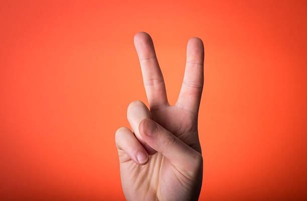 istock man's hand isolated on orange red background 466309847
