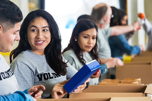 istock Latin couple sorting food donations while volunteering for charity 466310354