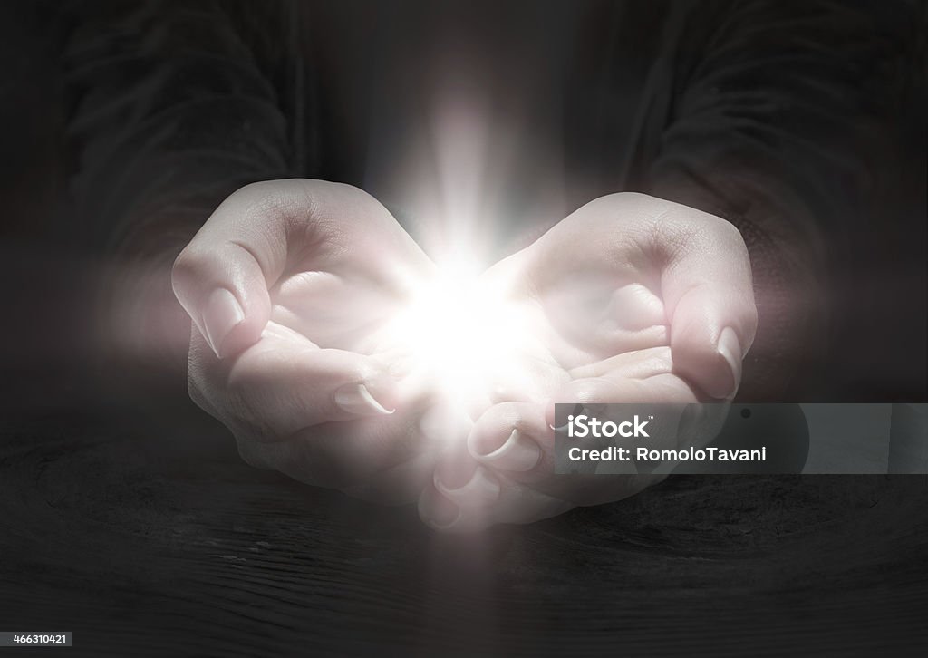 light in hands - rood pray the crucifix in darkness Light - Natural Phenomenon Stock Photo