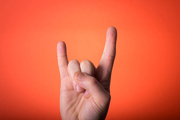 istock man's hand isolated on orange red background 466311343